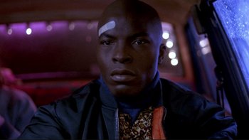 Movie still from “Night on Earth” (1991), directed by Jim Jarmusch – A person with a bandage on his head; Close Up shot, Low angle