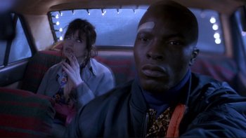 Movie still from “Night on Earth” (1991), directed by Jim Jarmusch – A man and a woman sitting in the back of a car; Close Up shot, Low angle