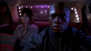 Movie still from “Night on Earth” (1991), directed by Jim Jarmusch – A man and a woman sitting in the back of a car; Close Up shot, Low angle