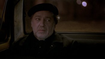 Movie still from “Night on Earth” (1991), directed by Jim Jarmusch – An older man wearing a hat sitting in the back of a car; Close Up shot, Over the shoulder angle