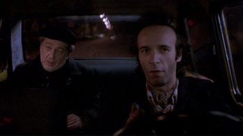 Movie still from “Night on Earth” (1991), directed by Jim Jarmusch – Two men sitting in the back seat of a car at night; Close Up shot, Over the shoulder angle