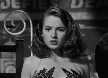 Movie still from “Nightmare Alley” (1947), directed by Edmund Goulding – A black and white photo of a woman in a dress; Close Up shot, Low angle