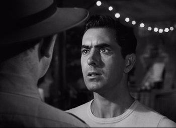 Movie still from “Nightmare Alley” (1947), directed by Edmund Goulding – Black and white photograph of a man looking at another man; Close Up shot, Over the shoulder angle