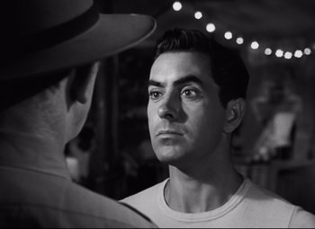 Movie still from “Nightmare Alley” (1947), directed by Edmund Goulding – A black - and - white photo of a man looking at another man; Close Up shot, Over the shoulder angle