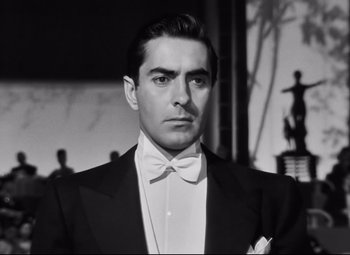 Movie still from “Nightmare Alley” (1947), directed by Edmund Goulding – Black and white photograph of a man in a tuxedo; Close Up shot, Low angle