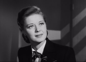 Movie still from “Nightmare Alley” (1947), directed by Edmund Goulding – A black - and - white photo of a woman wearing a suit; Close Up shot, Low angle