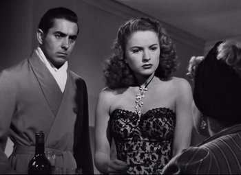 Movie still from “Nightmare Alley” (1947), directed by Edmund Goulding – A man and a woman standing next to each other; Medium shot, Over the shoulder angle