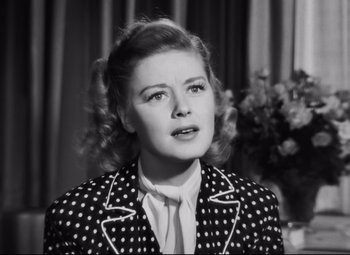 Movie still from “Nightmare Alley” (1947), directed by Edmund Goulding – An old black and white photo of a woman wearing a polka dot jacket; Close Up shot, Low angle