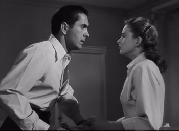 Movie still from “Nightmare Alley” (1947), directed by Edmund Goulding – A black and white photo of a man and a woman; Medium shot, Low angle