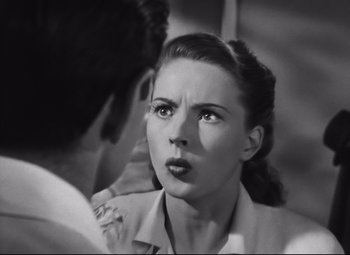 Movie still from “Nightmare Alley” (1947), directed by Edmund Goulding – An old photo of a man and a woman talking to each other; Close Up shot, Over the shoulder angle