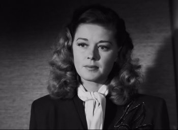 Movie still from “Nightmare Alley” (1947), directed by Edmund Goulding – A black and white photo of a woman in a suit; Close Up shot, Low angle