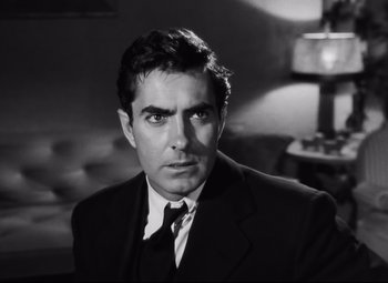 Movie still from “Nightmare Alley” (1947), directed by Edmund Goulding – Black and white photograph of a man wearing a suit and tie; Close Up shot, Low angle