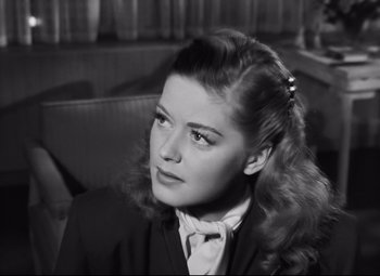 Movie still from “Nightmare Alley” (1947), directed by Edmund Goulding – A black - and - white photo of a woman in a suit; Close Up shot, High angle