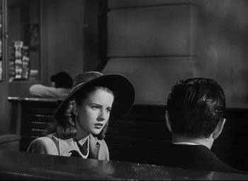 Movie still from “Nightmare Alley” (1947), directed by Edmund Goulding – A woman wearing a hat talking to a man in a suit; Close Up shot, Over the shoulder angle