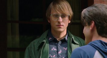 Movie still from “Nightmare Cinema” (2018), directed by Alejandro Brugués – A young man wearing glasses and a green jacket; Close Up shot, Over the shoulder angle