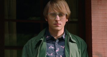 Movie still from “Nightmare Cinema” (2018), directed by Alejandro Brugués – A young man wearing glasses and a green jacket; Close Up shot, Over the shoulder angle