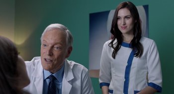 Movie still from “Nightmare Cinema” (2018), directed by Alejandro Brugués – A man and a woman in white lab coats in a room; Medium shot, Over the shoulder angle