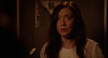 Movie still from “Nightmare Cinema” (2018), directed by Alejandro Brugués – A woman with long brown hair stares at the camera; Close Up shot, High angle