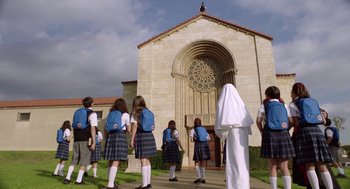 Movie still from “Nightmare Cinema” (2018), directed by Alejandro Brugués – A group of young girls standing in front of a church; Extreme Wide shot, Low angle