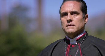 Movie still from “Nightmare Cinema” (2018), directed by Alejandro Brugués – A man wearing a priest's outfit looking at the camera; Close Up shot, Low angle