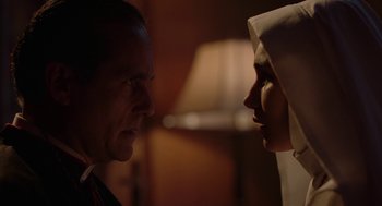 Movie still from “Nightmare Cinema” (2018), directed by Alejandro Brugués – A man and a woman face to face in front of a lamp; Close Up shot, Low angle