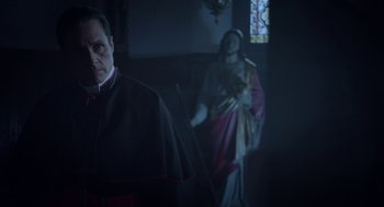 Movie still from “Nightmare Cinema” (2018), directed by Alejandro Brugués – A man wearing a black robe and a red cape; Medium shot, Low angle