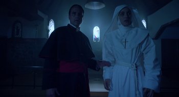 Movie still from “Nightmare Cinema” (2018), directed by Alejandro Brugués – A man and a woman dressed as a priest and nun; Medium shot, Low angle