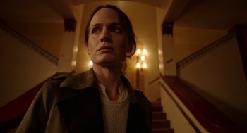 Movie still from “Nightmare Cinema” (2018), directed by Alejandro Brugués – A woman standing on a staircase looking up at the ceiling; Close Up shot, Low angle