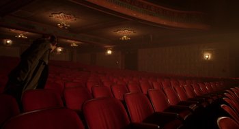 Movie still from “Nightmare Cinema” (2018), directed by Alejandro Brugués – A large auditorium with red seats in it; Extreme Wide shot, High angle