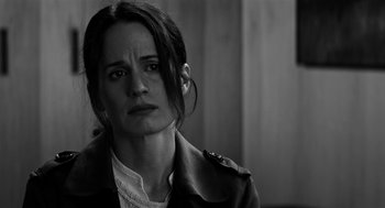 Movie still from “Nightmare Cinema” (2018), directed by Alejandro Brugués – Black and white photograph of a woman looking sad; Close Up shot, Over the shoulder angle