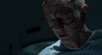 Movie still from “Nightmare Cinema” (2018), directed by Alejandro Brugués – A person with a scar on his face; Close Up shot, Low angle