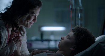 Movie still from “Nightmare Cinema” (2018), directed by Alejandro Brugués – A young boy laying in a hospital bed next to an older woman; Close Up shot, Over the shoulder angle
