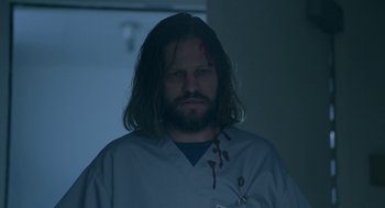 Movie still from “Nightmare Cinema” (2018), directed by Alejandro Brugués – A man with blood on his face is standing in a room; Close Up shot, Low angle