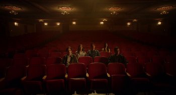 Movie still from “Nightmare Cinema” (2018), directed by Alejandro Brugués – A group of people sitting in a movie theater; Extreme Wide shot, High angle