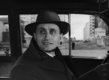 Movie still from “Nights of Cabiria” (1957), directed by Federico Fellini – A black and white photo of a man wearing a hat; Close Up shot, Low angle