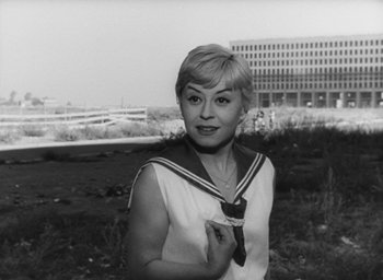 Movie still from “Nights of Cabiria” (1957), directed by Federico Fellini – An old photo of a woman in a sailor's outfit; Medium shot, Low angle