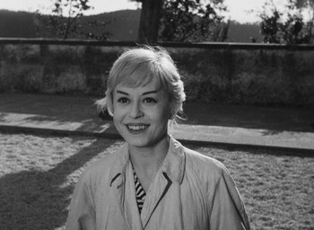 Movie still from “Nights of Cabiria” (1957), directed by Federico Fellini – Black and white photograph of a woman smiling for the camera; Close Up shot, High angle