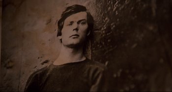 An old photo of a man in a black t - shirt
