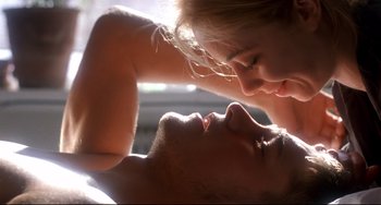 A man and a woman laying on top of each other