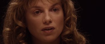 Movie still from “Nightwatching” (2007), directed by Peter Greenaway – A woman's face with curly brown hair; Close Up shot, Over the shoulder angle