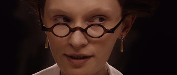 Movie still from “Nightwatching” (2007), directed by Peter Greenaway – A person wearing glasses and a white shirt; Extreme Close Up shot, Over the shoulder angle