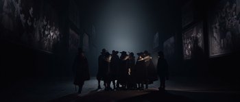 Movie still from “Nightwatching” (2007), directed by Peter Greenaway – A group of people standing in a dark room; Wide shot, High angle