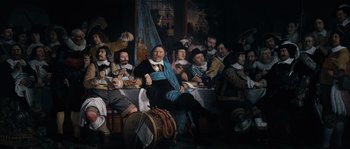 Movie still from “Nightwatching” (2007), directed by Peter Greenaway – A group of people sitting around a table; Wide shot, Low angle