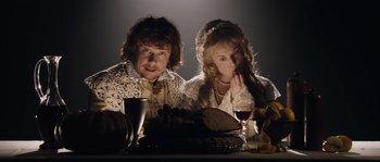 Movie still from “Nightwatching” (2007), directed by Peter Greenaway – A man and a woman sitting at a dinner table; Medium shot, Over the shoulder angle