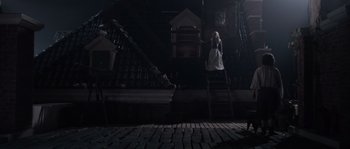 Movie still from “Nightwatching” (2007), directed by Peter Greenaway – A woman standing on a ladder in a dark room; Wide shot, Low angle