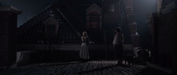 Movie still from “Nightwatching” (2007), directed by Peter Greenaway – Two people standing in a dark room near a staircase; Wide shot, High angle