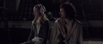 Movie still from “Nightwatching” (2007), directed by Peter Greenaway – A man and a woman sitting next to each other; Medium shot, Over the shoulder angle