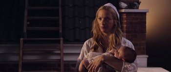 Movie still from “Nightwatching” (2007), directed by Peter Greenaway – A woman holding a baby in her arms; Close Up shot, Over the shoulder angle