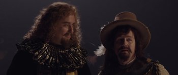 Movie still from “Nightwatching” (2007), directed by Peter Greenaway – A man with long hair and a man with a hat; Close Up shot, Over the shoulder angle