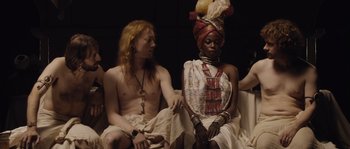 Movie still from “Nightwatching” (2007), directed by Peter Greenaway – A man and a woman sitting next to each other; Medium shot, High angle